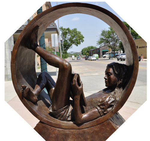 Girl in a circle reading a book sculpture