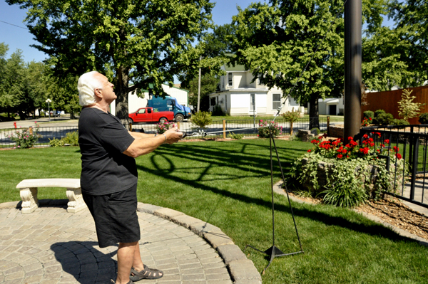 Lee Duquette pulling on the cord to ring The World's Largest Wind Chime