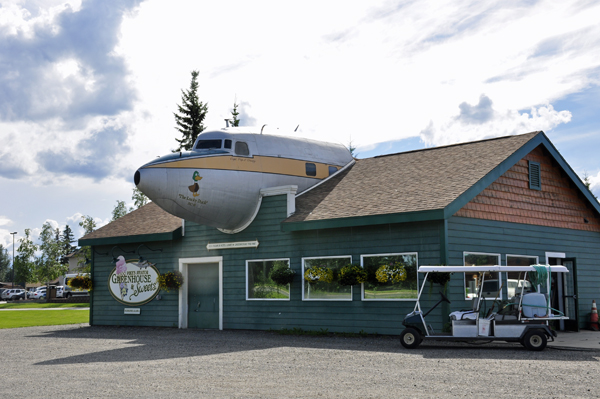An airplane sticking out of a building