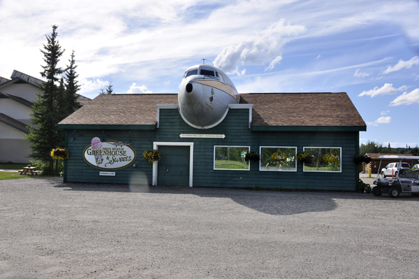 An airplane sticking out of a building