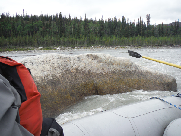 giant boulder sticking up out of the river