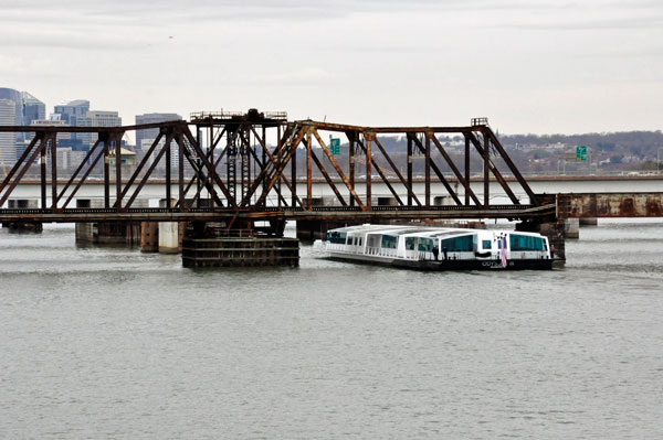 boat going under a railroad bridge