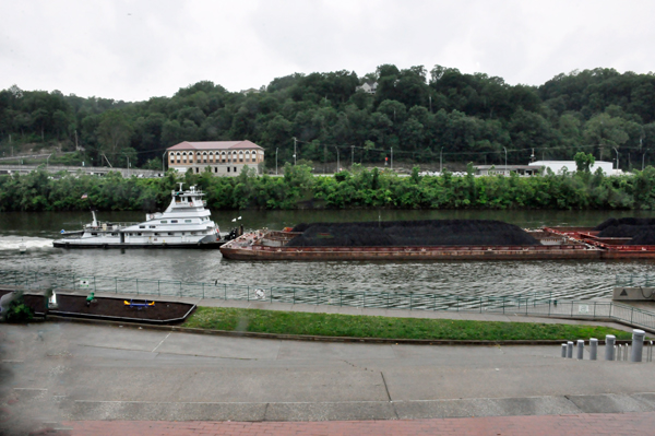 tug pushing a load of coal