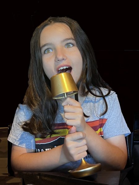 Gabby singing into a lamp